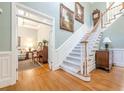 Grand foyer showcasing hardwood floors, staircase, and access to formal living spaces at 1364 Gulfport Run, Grayson, GA 30017