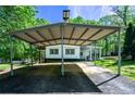 Carport with a gravel parking pad and overhead light at 1369 N Highway 16, Whitesburg, GA 30185