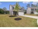 Beautifully landscaped front yard of a well-kept home, complete with a two-car garage at 231 Limestone Cir, Conyers, GA 30013