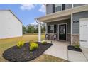 Welcoming front porch with seating area, complementing the charming exterior of the home at 231 Limestone Cir, Conyers, GA 30013