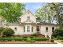 Charming two-story home with landscaped yard featuring manicured hedges and lush green trees on a beautiful lot at 511 Sycamore St, Decatur, GA 30030