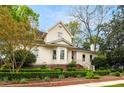 Charming two-story home with landscaped yard featuring manicured hedges and lush green trees on a beautiful lot at 511 Sycamore St, Decatur, GA 30030