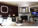 Cozy living room with a fireplace, comfortable seating, and hardwood floors at 1920 Stancrest Nw Trce, Kennesaw, GA 30152