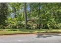 Charming two-story brick home with manicured lawn and mature trees offers a serene setting at 4111 Mcclatchey Ne Cir, Atlanta, GA 30342