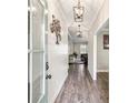 Entryway of home with hardwood floors and view into the living room at 461 Silver St, Buford, GA 30518