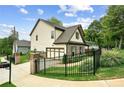 View of the home's side yard, driveway, brick and siding details, and two-car garage at 461 Silver St, Buford, GA 30518