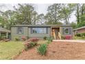 Inviting home featuring a lush front yard with vibrant flowers and a freshly painted exterior at 525 Rosemont Dr, Decatur, GA 30032