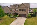 Traditional two-story brick home with landscaped yard and attached two-car garage at 590 Birkdale Dr, Fairburn, GA 30213