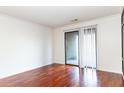 A well lit living room has beautiful hardwood floors, neutral wall color and a sliding glass door to the outside at 2657 Lenox Ne Rd # 68 Bld, Atlanta, GA 30324