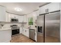 Modern kitchen with stainless steel appliances, white cabinets, and granite countertops at 3181 Pennington Sw Cir, Atlanta, GA 30354