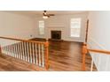 Open-concept living area with a fireplace, hardwood floors, and natural light at 3572 Stone Ridge Trl, Douglasville, GA 30134