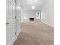 Expansive carpeted living room featuring a fireplace and large windows, offering ample natural light at 6416 Chestnut Glen Dr, Norcross, GA 30071