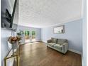 Cozy living room with hardwood floors, neutral paint, and French doors to the outdoor patio at 664 Somerset Dr, Lawrenceville, GA 30046