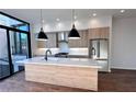 Modern kitchen with marble countertops, wooden cabinets, stainless steel appliances, and black pendant lights at 105 Georgia Se Ave # 6, Atlanta, GA 30312