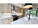 This is a kitchen with wood grain cabinets, stainless steel appliances and a large white countertop island at 105 Georgia Se Ave # 6, Atlanta, GA 30312