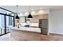 The kitchen features wood grain cabinets, stainless steel appliances, a white countertop island, and large windows at 105 Georgia Se Ave # 6, Atlanta, GA 30312