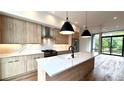 This is a kitchen with wood grain cabinets, stainless steel appliances and a large white countertop island at 105 Georgia Se Ave # 6, Atlanta, GA 30312