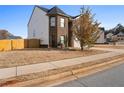 A view of a two story home's side with a brick facade and vinyl siding at 165 Twin Lakes Dr, Covington, GA 30016