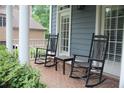 Inviting front porch featuring rocking chairs, creating a cozy outdoor seating area, next to bright windows at 4877 Registry Nw Ln, Kennesaw, GA 30152