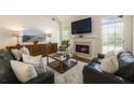 Inviting living room with a cozy fireplace, hardwood floors, neutral colors and plenty of natural light at 1000 Stethem Fry, Johns Creek, GA 30022