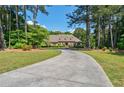 Beautiful brick home featuring manicured landscaping and long driveway at 1551 Pharrs Rd., Snellville, GA 30078