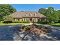 Beautiful brick home featuring manicured landscaping and circular driveway with a fountain at 1551 Pharrs Rd., Snellville, GA 30078