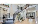 Grand foyer with modern staircase, hardwood floors, high ceilings, and stylish lighting fixture at 2015 Shaudi Ln, Atlanta, GA 30345