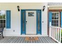 Front door features stylish blue trim, black sconces, and a gray wooden porch at 2949 Lake Spivey Pkwy, Jonesboro, GA 30236
