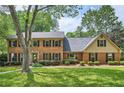Beautiful two-story brick home with lush green lawn and mature landscaping, exudes classic elegance and charm at 3635 Norwich Dr, Tucker, GA 30084