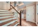 Elegant foyer with hardwood floors, a staircase with decorative spindles, and classic trim details at 3635 Norwich Dr, Tucker, GA 30084