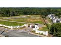 Aerial view of new home construction with lush surroundings and community entrance at 1510 Gatekeeper Ter, Marietta, GA 30066