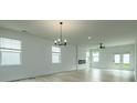 Open living room boasts tons of natural light, ceiling fan, modern light fixtures, and a fireplace at 1510 Gatekeeper Ter, Marietta, GA 30066