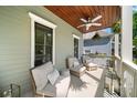 Relaxing covered porch with comfortable seating and charming wood plank ceiling at 94 Hogue Ne St, Atlanta, GA 30312