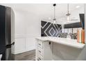 Stylish kitchen with white countertops, modern appliances, pendant lighting, and bar seating area at 215 Piedmont Ne Ave # 2210, Atlanta, GA 30308