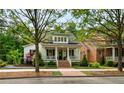 Inviting two-story home with a classic white exterior, complemented by dark shutters and lush landscaping at 5134 Pratt Sw St, Covington, GA 30014
