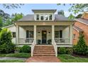 Attractive two-story home featuring a covered front porch with stylish columns and a well-maintained brick walkway at 5134 Pratt Sw St, Covington, GA 30014