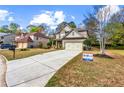 Suburban home featuring a long driveway, well-kept lawn, and traditional two-story architecture at 635 Crosswinds Cir, Marietta, GA 30008
