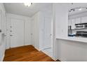 Bright entryway with white trim, hardwood floors, and a view into the updated kitchen at 1250 Parkwood Se Cir # 3101, Atlanta, GA 30339