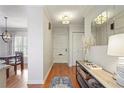 Welcoming entryway with hardwood floors, decorative mirror, console table, and access to dining area at 25 Ivy Gates Ne, Atlanta, GA 30342