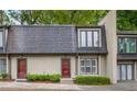 Two-story townhouse with a neutral exterior, red front doors, and well-maintained landscaping at 25 Ivy Gates Ne, Atlanta, GA 30342