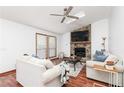 Bright living room with vaulted ceilings, a ceiling fan, a stone fireplace, and hardwood floors at 4065 Maxanne Nw Dr, Kennesaw, GA 30144