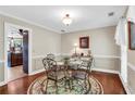 Cozy dining area featuring a round glass table, elegant chairs, and warm lighting at 4702 Sequoia Sw Dr, Lilburn, GA 30047