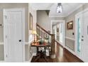 Inviting entryway with hardwood floors, decorative moldings, and a staircase leading to the upper level at 4702 Sequoia Sw Dr, Lilburn, GA 30047