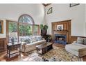 Bright living room boasts a fireplace, large windows, high ceilings, and hardwood floors at 1824 Mallard Lake Dr, Marietta, GA 30068