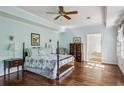 Serene main bedroom showcases hardwood floors, an ensuite bathroom, and a ceiling fan at 1824 Mallard Lake Dr, Marietta, GA 30068
