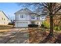 Two-story home with a two-car garage, driveway, landscaped yard, and inviting curb appeal at 233 Hampton Station Blvd, Canton, GA 30115