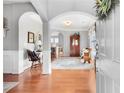 Elegant foyer featuring hardwood floors, arched doorways, wainscoting and ample natural light at 233 Hampton Station Blvd, Canton, GA 30115
