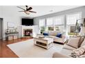 Bright and airy living room featuring a fireplace, hardwood floors, and comfortable seating at 233 Hampton Station Blvd, Canton, GA 30115