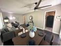 Open concept living room and dining area featuring stylish furniture, modern fan, and elegant decor at 1900 Meadow Ln, Decatur, GA 30032