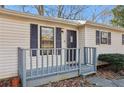 Close-up of a cozy front porch with gray railings and a view of the entry door at 409 Katherine Ln, Woodstock, GA 30189